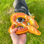 Playful dog chewing Doggijuana Pretzel Toy outdoors, promoting stress relief and engaging chewing fun with built-in Juananip.