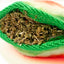 Close-up of Juananip stuffing inside the Watermelon Slice dog toy, showing premium organic calming blend in refillable pocket.